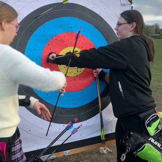 Archers removing arrows from target face